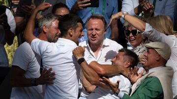 LONDON, ENGLAND - JULY 10: Novak Djokovic of Serbia hugs his team and family after winning his match against Nick Kyrgios of Australia during their Men's Singles Final match on day fourteen of The Championships Wimbledon 2022 at All England Lawn Tennis and Croquet Club on July 10, 2022 in London, England. (Photo by Visionhaus/Getty Images)