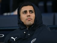 Manchester City's Spanish midfielder #16 Rodri takes his place on the bench for the English Premier League football match between Manchester City and Bournemouth at the Etihad Stadium in Manchester, north west England, on November 2, 2025. (Photo by Paul ELLIS / AFP) / RESTRICTED TO EDITORIAL USE. No use with unauthorized audio, video, data, fixture lists, club/league logos or 'live' services. Online in-match use limited to 120 images. An additional 40 images may be used in extra time. No video emulation. Social media in-match use limited to 120 images. An additional 40 images may be used in extra time. No use in betting publications, games or single club/league/player publications. /