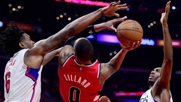 LOS ANGELES, CA - DECEMBER 12: Damian Lillard #0 of the Portland Trail Blazers attempts a shot between DeAndre Jordan #6 and Luc Mbah a Moute #12 of the LA Clippers during the first half at Staples Center on December 12, 2016 in Los Angeles, California. NOTE TO USER: User expressly acknowledges and agrees that, by downloading and or using this photograph, User is consenting to the terms and conditions of the Getty Images License Agreement.   Harry How/Getty Images/AFP
 == FOR NEWSPAPERS, INTERNET, TELCOS &amp; TELEVISION USE ONLY ==