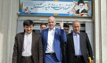 FIFA President Gianni Infantino (C) walks with Iranian Football Federation President Mehdi Taj (R) after his meeting with Iran's Minister of Sport and Youth (unseen) during his visit to the capital Tehran on March 1, 2018.