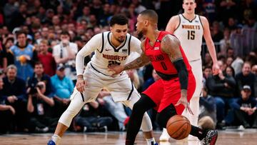 May 1, 2019; Denver, CO, USA; Portland Trail Blazers guard Damian Lillard (0) controls the ball as Denver Nuggets guard Jamal Murray (27) defends in the fourth quarter in game two of the second round of the 2019 NBA Playoffs at the Pepsi Center. Mandatory Credit: Isaiah J. Downing-USA TODAY Sports