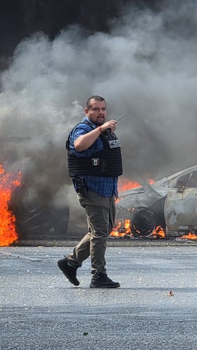 Police officers secure the area where vehicles were set on fire by organized crime members to block a road following a military operation in which a government source said Mexican drug lord Nemesio Oseguera, commonly known as "El Mencho," was killed, in Zapopan, Mexico, February 22, 2026. REUTERS/Gilberto Gallo