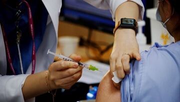 FILE PHOTO: A health worker gets a dose of the Pfizer-BioNTech coronavirus disease (COVID-19) vaccine at a COVID-19 vaccination center in Seoul, South Korea, March 10, 2021.  REUTERS/Kim Hong-Ji/File Photo/File Photo