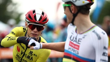 UAE Team Emirates' Slovenian rider Tadej Pogacar (R) fist bumps with Team Visma-Lease a Bike's Danish rider Jonas Vingegaard prior to the start of the 1st stage of the 77th edition of the Criterium du Dauphine cycling race, 195,8 km between Dom�rat and Montlucon, on June 8, 2025. (Photo by Anne-Christine POUJOULAT / AFP)