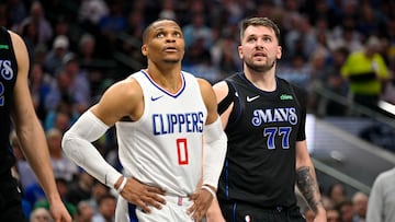 May 3, 2024; Dallas, Texas, USA; LA Clippers guard Russell Westbrook (0) and Dallas Mavericks guard Luka Doncic (77) look for the ball on a foul shot during the first quarter during game six of the first round for the 2024 NBA playoffs at American Airlines Center. Mandatory Credit: Jerome Miron-USA TODAY Sports