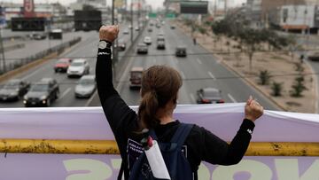 Lilian Morales, whose daughter was a victim of gender violence, holds a sign from an overpass on the International Day for the Elimination of Violence Against Women, in Lima, Peru November 25, 2021. REUTERS/Angela Ponce
