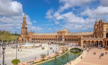 El núcleo histórico de Sevilla es bastante compacto, pero si visitas Triana, a través del Guadalquivir, y la Isla de la Cartuja, las distancias se hacen más evidentes. A los ojos del foráneo, la Feria de Abril y la Semana Santa pueden ser los motivos más recurrentes de visita, pero el Real Alcázar, un complejo de palacios, fortificaciones, patios, piscinas reflectantes y hermosos jardines y olivares dispuestos en una cuidada cuadrícula, es una delicia. Imperdonable no visitar la Plaza de España, la Giralda o la Torre Del Oro. Además, sus barrios, llenos de arte y embrujo, ofrecen innumerables rincones para disfrutar de la gastronomía y del flamenco. Como dice la canción, Sevilla tiene un color especial.