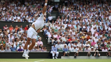 Serbia's Novak Djokovic serves to Poland's Hubert Hurkacz during their men's singles tennis match on the eighth day of the 2023 Wimbledon Championships at The All England Tennis Club in Wimbledon, southwest London, on July 10, 2023. (Photo by Adrian DENNIS / AFP) / RESTRICTED TO EDITORIAL USE