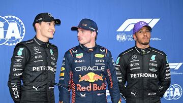 Pole position qualifier Red Bull Racing's Dutch driver Max Verstappen (C) poses with second qualifying positioned Mercedes' British driver George Russell (L) and third qualifying positioned Mercedes' British driver Lewis Hamilton
