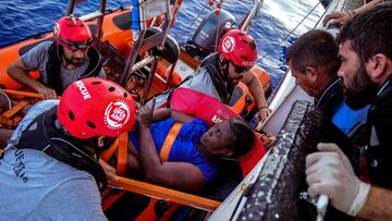 NBA Memphis player Marc Gasol and members of NGO Proactiva Open Arms rescue boat carry an African migrant in central Mediterranean Sea, July 17, 2018. REUTERS/Juan Medina RESCATE MEDITERRANEO