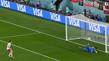 Mexico's goalkeeper #13 Guillermo Ochoa stops a penalty kick taken by Poland's forward #09 Robert Lewandowski during the Qatar 2022 World Cup Group C football match between Mexico and Poland at Stadium 974 in Doha on November 22, 2022. (Photo by Glyn KIRK / AFP)