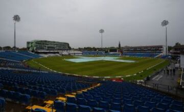 Covers sit over the wicket as rain halts play on the first day of the first cricket Test match between England and Sri Lanka at Headingley in Leeds, northern England on May 19, 2016.