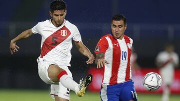 Peru's Carlos Zambrano, left, and Paraguay's Dario Lezcano fight for the ball during a qualifying soccer match for the FIFA World Cup Qatar 2022 at the Defensores del Chaco stadium, in Asuncion, Paraguay, Thursday, Oct.8, 2020. (AP Photo/Jorge Saenz)