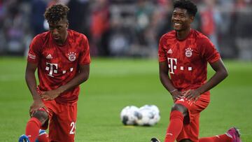 Bayern Munich's French defender Kingsley Coman (L) and Bayern Munich's Austrian defender David Alaba (R) warm up prior to the German First division Bundesliga football match FC Bayern Munich v Hertha Berlin in Munich, southern Germany, on August