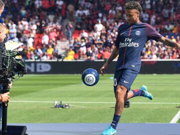 Paris Saint-Germain&#039;s Brazilian forward Neymar plays with a ball on stage during his presentation to the fans at the Parc des Princes stadium in Paris on August 5, 2017.
 Brazil superstar Neymar will watch from the stands as Paris Saint-Germain open their season on August 5, 2017, but the French club have already clawed back around a million euros on their world record investment. Neymar, who signed from Barcelona for a mind-boggling 222 million euros ($264 million), is presented to the PSG support prior to his new team&#039;s first game of the Ligue 1 campaign against promoted Amiens.
  / AFP PHOTO / ALAIN JOCARD