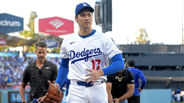 Jun 16, 2025; Los Angeles, California, USA; Los Angeles Dodgers starting pitcher Shohei Ohtani (17) enters the dugout after warming up for the game against the San Diego Padres at Dodger Stadium. Mandatory Credit: Jayne Kamin-Oncea-Imagn Images