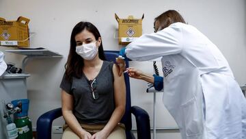 ACOMPAÑA CRÓNICA: BRASIL CORONAVIRUS AME9586. SAO PAULO (BRASIL), 20/08/2020.- La fisioterapeuta, Graziela Domingues, recibe la segunda dosis en los ensayos de la vacuna contra el COVID-19 desarrollada por el laboratorio chino Sinovac Biotech, el 14 de agosto de 2020 en el hospital Emilio Ribas en Sao Paulo (Brasil). Son ya casi seis meses bajo una enorme presión emocional. Los profesionales sanitarios de Brasil se sienten agotados, exhaustos, después de medio año de batalla contra el coronavirus. Cerca 260.000 se han contagiado y al menos 226 han dado su vida por esta crisis. EFE/Sebastiao Moreira