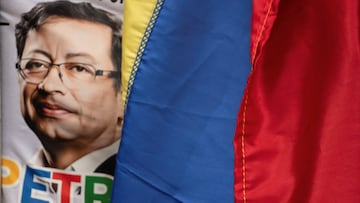 A poster with the image of Colombian President Gustavo Petro is seen next to a flag during the rally for peace and democracy at San Francisco Square in Cali, Colombia June 11, 2025. REUTERS/Sebastian Marmolejo