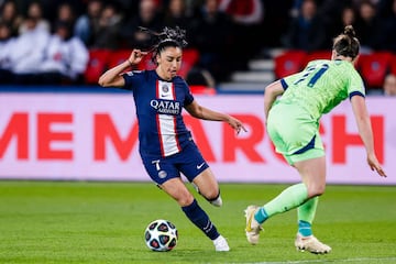 Sakina Karchaoui of Paris Saint-Germain (L) dribbles Alexandra Popp of Wolfsburg 