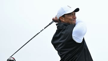 (FILES) In this file photo taken on July 15, 2022, US golfer Tiger Woods watches his drive from the second tee during his second round on the day two of The 150th British Open Golf Championship on The Old Course at St Andrews in Scotland. - Tiger Woods said on November 9, 2022, he would be returning to action at the Hero World Challenge in what will be the golf great's first tournament since the British Open in July. (Photo by Glyn KIRK / AFP) / RESTRICTED TO EDITORIAL USE