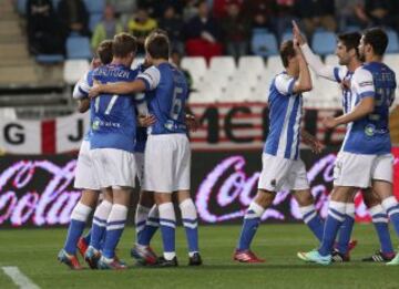 Los jugadores de la Real Sociedad celebran el primer gol del equipo, conseguido por el mexicano Carlos Vela, durante el partido, correspondiente a la vigésimo novena jornada de Liga en Primera División, que UD Almería y Real Sociedad juegan esta noche en el estadio de los Juegos Mediterráneos.