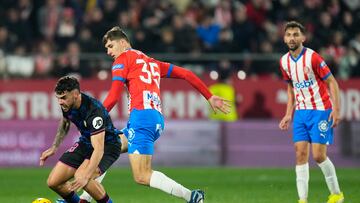 GIRONA, 21/01/2024.- El defensa del Girona Antal Yaakobishvili (c) y el delantero del Sevilla Isaac Romero durante el partido correspondiente a la jornada 21 de LaLiga que enfrenta este domingo al Girona y al Sevilla en el estadio de Montilivi.EFE/ Siu Wu