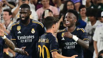 Real Madrid's Brazilian midfielder Vini Jr. (R) celebrates scoring his team's third goal with teammates during the friendly football match between Real Madrid and AC Milan at the Rose Bowl in Pasadena, California, on July 23, 2023. (Photo by Frederic J. BROWN / AFP)