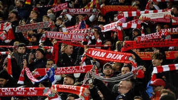 Liverpool fans raise their scarves in the crowd ahead of the English Premier League football match between Liverpool and Leicester City at Anfield in Liverpool, north west England on February 10, 2022. (Photo by Oli SCARFF / AFP) / RESTRICTED TO EDITORIAL USE. No use with unauthorized audio, video, data, fixture lists, club/league logos or 'live' services. Online in-match use limited to 120 images. An additional 40 images may be used in extra time. No video emulation. Social media in-match use limited to 120 images. An additional 40 images may be used in extra time. No use in betting publications, games or single club/league/player publications. / 