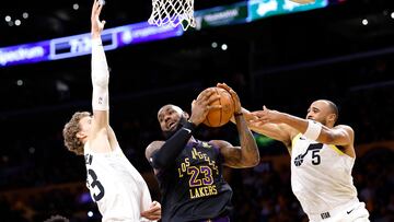 LeBron James #6 of the Los Angeles Lakers is double-teamed by Talen Horton-Tucker #5 and Lauri Markkanen #23 of the Utah Jazz