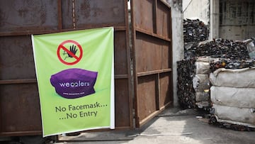 Lagos (Nigeria), 05/06/2020.- A banner informing workers of the compulsion to wear face masks to mitigate the risk of infection with the SARS-CoV-2 coronavirus that causes the pandemic COVID-19 disease hangs at the entrance of the Wecycler recycling and w