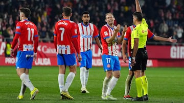 Girona's Dutch defender #17 Daley Blind receives a yellow card from Spanish referee Jesus Gil Manzano during the Spanish league football match between Girona FC and Real Sociedad at the Montilivi stadium in Girona on February 3, 2024. (Photo by Pau Barrena / AFP)