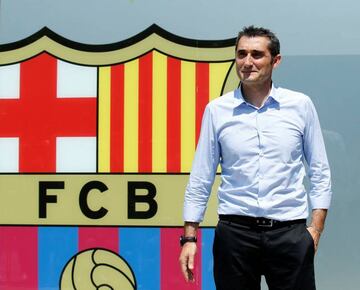 Coach Ernesto Valverde poses in front of FC Barcelona's giant logo at their offices at Camp Nou Stadium in Barcelona