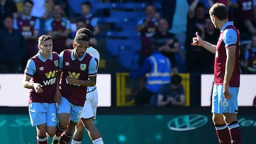 Burnley's Northern Irish midfielder #24 Josh Cullen (L) celebrates with teammates after scoring a goal during the English Premier League football match between Burnley and Nottingham Forest at Turf Moor in Burnley, north-west England on May 19, 2024. (Photo by ANDY BUCHANAN / AFP) / RESTRICTED TO EDITORIAL USE. No use with unauthorized audio, video, data, fixture lists, club/league logos or 'live' services. Online in-match use limited to 120 images. An additional 40 images may be used in extra time. No video emulation. Social media in-match use limited to 120 images. An additional 40 images may be used in extra time. No use in betting publications, games or single club/league/player publications. / 