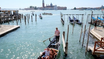 FILE PHOTO: People ride on a gondola as the municipality prepares to charge tourists up to 10 Euro for entry into the lagoon city, in order to cut down the number of visitors, in Venice, Italy, September 5, 2021. REUTERS/Manuel Silvestri/File Photo