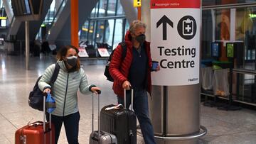 A sign directs passengers to a Covid-19 testing centre at Terminal 5 of London Heathrow Airport in west London on February 9, 2021. - Travellers arriving in Britain from abroad will have to take two coronavirus tests during quarantine, the government conf