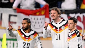 Germany's forward #11 Nick Woltemade (C) celebrates scoring his team's first goal with Germany's midfielder #20 Serge Gnabry (L) and Germany's midfielder #17 Florian Wirtz during the 2026 World Cup qualifiers Europe zone group A football match between Luxembourg and Germany at the Luxembourg Stadium in Luxembourg on November 14, 2025. (Photo by JOHN THYS / AFP)