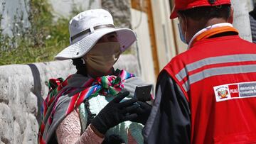 A woman is interviewed by staff of the Ministry of Women and Vulnerable Populations while holding a queue position outside a Pension Funds Administrator institution in the Andean city of Puno, close to the Bolivian border, to request information about the withdrawal of up to the equivalent of 1,080 US dollars in national currency from their pension funds to alleviate the crisis caused by the confinement in force for two months to combat the coronavirus on May 19, 2020. - A law published on April 30, authorizes members of the private pension system to &quot;voluntarily and extraordinarily, withdraw up to 25% of your total accumulated funds &quot;, up to a maximum of 3,700 Peruvian Soles per person. More than six million Peruvians can request the withdrawal which economists have warned will have &quot;long-term pernicious effectsx94. (Photo by Carlos MAMANI / AFP)