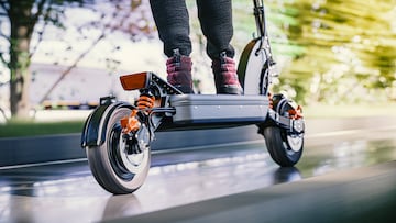 Electric scooter fast ride through the city - closeup to back wheel, motion blur effect
