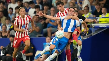 CORNELLÁ-EL PRAT, 17/08/2025.- El defensa del Atlético de Madrid Robin Le Normand (d-detrás) lucha con Kike García (d), del Espanyol, durante el partido de la primera jornada de LaLiga que RDC Espanyol y Atlético de Madrid juegan este domingo en el RCDE Stadium. EFE/Enric Fontcuberta