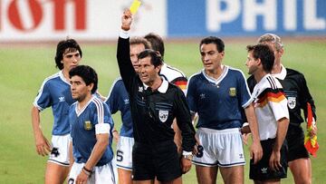 Mexican referee Ernesto Codesal Mendez gives a yellow card to Argentinian midfielder Diego Maradona (L) 08 July 1990 in Rome during the World Cup soccer final between Argentina and West Germany. The defending world champions lost 1-0 to West Germany after finishing the game with two men short. AFP PHOTO 
STAFF / AFP