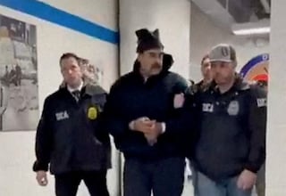 A still image from video posted by the White House's Rapid Response 47 account on X.com, which originated from the @PaulDMauro account, shows Venezuela's President Nicolas Maduro being walked in custody down a hallway at the offices of the U.S. Drug Enforcement Administration (DEA) in New York City, U.S., January 3, 2026. @RapidResponse47/Handout via REUTERS THIS IMAGE HAS BEEN SUPPLIED BY A THIRD PARTY. MANDATORY CREDIT.NO RESALES. NO ARCHIVES. THIS PICTURE WAS PROCESSED BY REUTERS TO ENHANCE QUALITY. AN UNPROCESSED VERSION HAS BEEN PROVIDED SEPARATELY. TPX IMAGES OF THE DAY Verification - Reuters was able to confirm footage of Nicolas Maduro walking through the halls of DEA headquarters in New York as seen on corroborating footage showing same personnels ushering Maduro and DEA NYD crest on the wall. - Logo on wall matched DEA NYD from file images. - Reuters witness footage showing convoy arriving at DEA headquarters in Manhattan.
