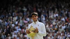 Spain's Carlos Alcaraz poses with the winner's trophy after beating Serbia's Novak Djokovic during their men's singles final tennis match on the fourteenth day of the 2024 Wimbledon Championships at The All England Lawn Tennis and Croquet Club in Wimbledon, southwest London, on July 14, 2024. Defending champion Alcaraz beat seven-time winner Novak Djokovic in a blockbuster final, with Alcaraz winning 6-2, 6-2, 7-6. (Photo by ANDREJ ISAKOVIC / AFP) / RESTRICTED TO EDITORIAL USE
