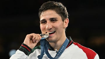 Silver medallist Mexico's Marco Alonso Verde Alvarez celebrates on the podium during the medal ceremony for the men's 71kg final boxing category during the Paris 2024 Olympic Games at the Roland-Garros Stadium, in Paris on August 9, 2024. (Photo by MOHD RASFAN / AFP)