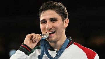 Silver medallist Mexico's Marco Alonso Verde Alvarez celebrates on the podium during the medal ceremony for the men's 71kg final boxing category during the Paris 2024 Olympic Games at the Roland-Garros Stadium, in Paris on August 9, 2024. (Photo by MOHD RASFAN / AFP)