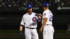Chicago Cubs&#039; Jon Lester, left, fist-bumps first base coach Will Venable (25) after his two-RBI single during the third inning of a baseball game against the New York Mets on Monday, Aug, 27, 2018, in Chicago. (AP Photo/Matt Marton)