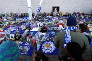 Leicester City football fans pay their respects outside the football stadium, after the helicopter of the club owner Thai businessman Vichai Srivaddhanaprabha crashed when leaving the ground on Saturday evening after the match