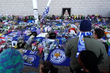 Leicester City football fans pay their respects outside the football stadium, after the helicopter of the club owner Thai businessman Vichai Srivaddhanaprabha crashed when leaving the ground on Saturday evening after the match