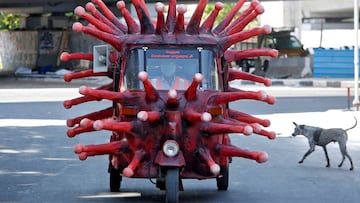 FILE PHOTO: A man drives an auto-rickshaw depicting the coronavirus to create awareness about staying at home during a nationwide lockdown to slow the spreading of the coronavirus disease (COVID-19), in Chennai, India, April 23, 2020. REUTERS/P. Ravikumar