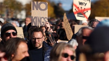 Demonstrators hold signs to protest against U.S. President Donald Trump and his administration during a 'No Kings' rally near the U.S. embassy in Berlin, Germany, October 18, 2025. REUTERS/Christian Mang