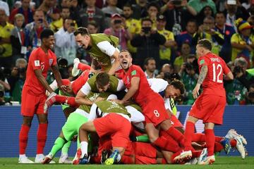 England's team players celebrate after winning their last 16 match at the 2018 World Cup against Colombia.